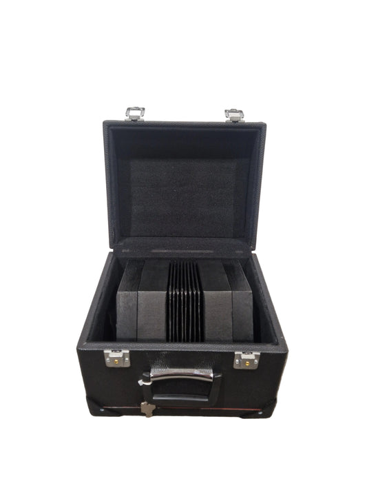 Black briefcase with a stack of black folders on a gray surface