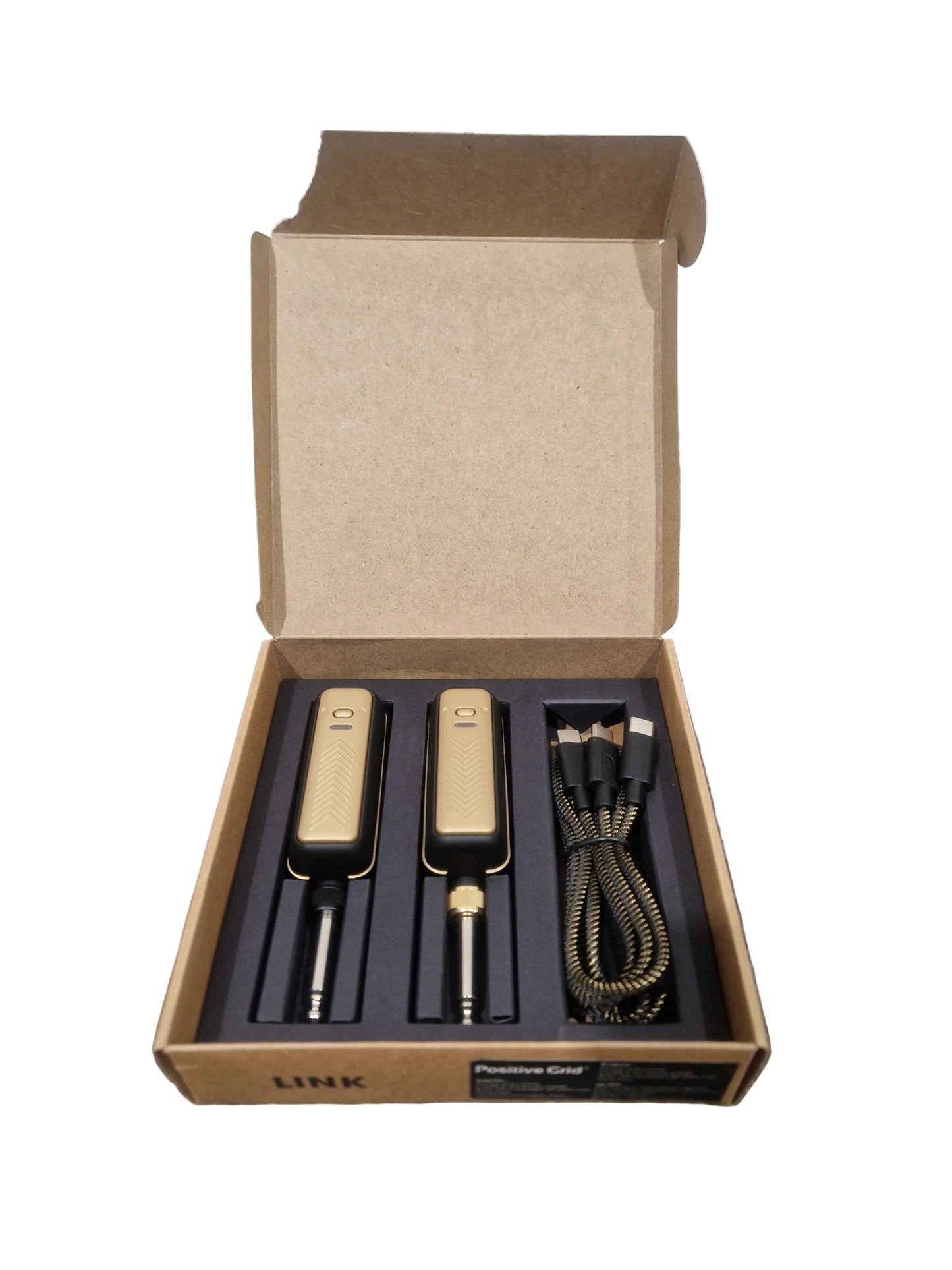 Set of tools in an open cardboard box on a textured surface