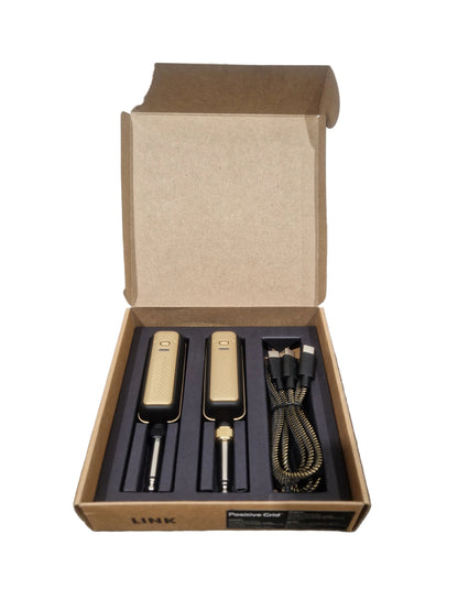 Set of tools in an open cardboard box on a textured surface