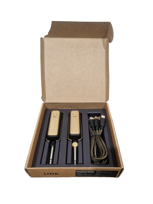 Set of tools in an open cardboard box on a textured surface