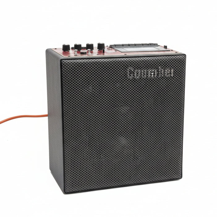 Black audio amplifier on a gray concrete floor