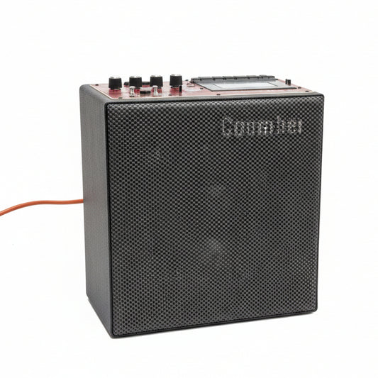 Black audio amplifier on a gray concrete floor