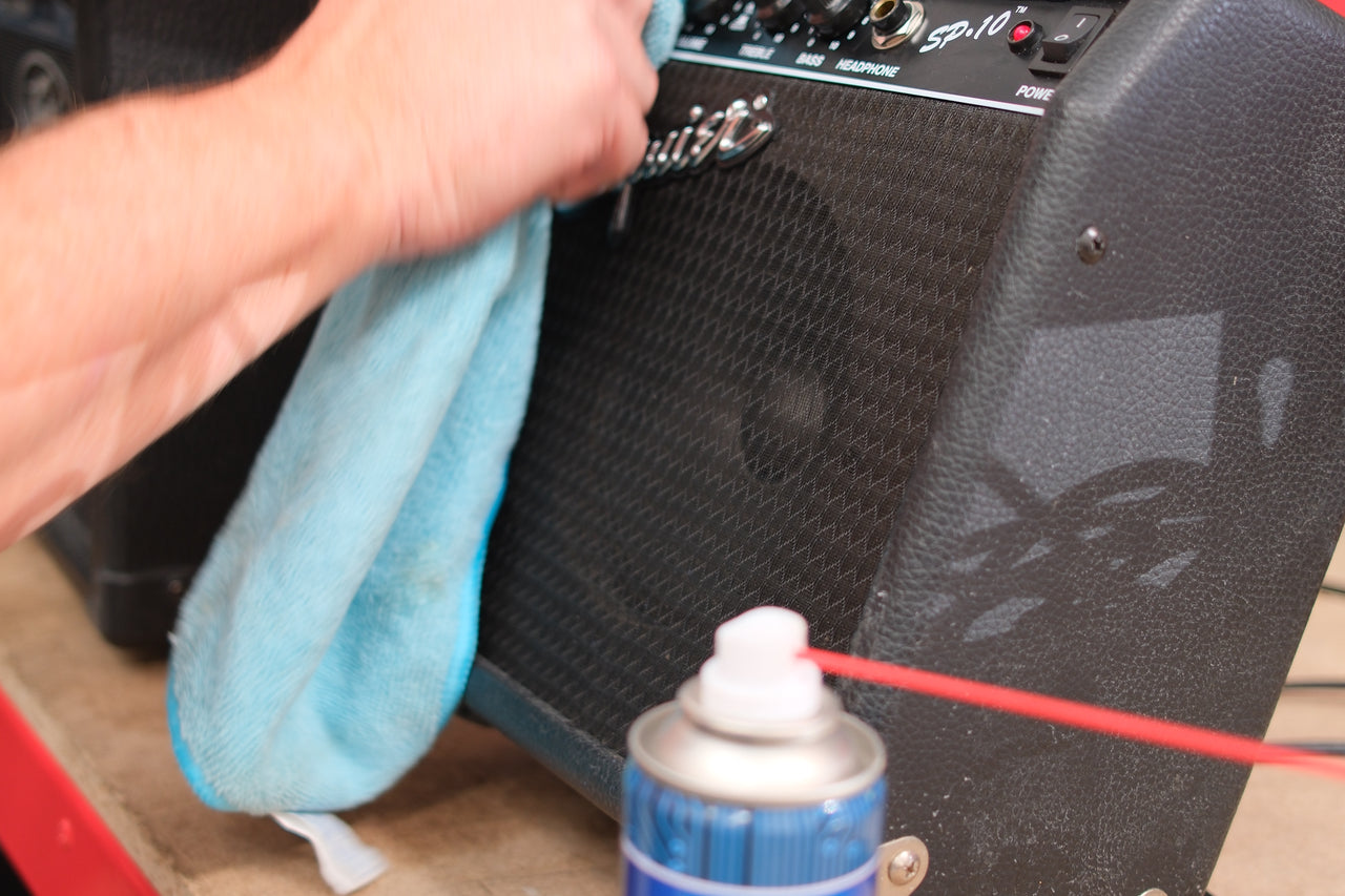 Cleaning an amplifier control panel by hand
