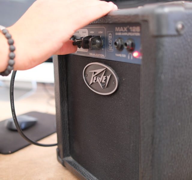 Plugging an instrument cable into an amplifier