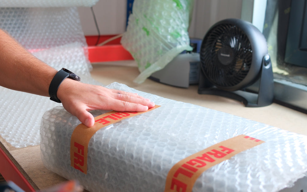 Applying fragile tape to a wrapped item