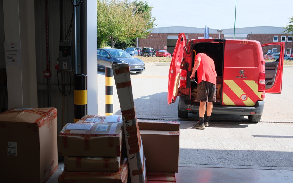 Courier collecting parcels from the warehouse